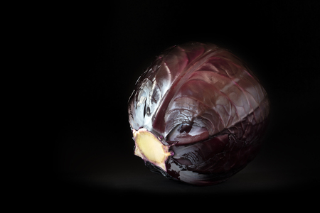 whole red cabbage on a very dark background with copy space, selected focusの写真素材