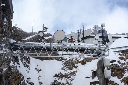 Meteorological weather station on the Zugspitze, the highest mountain of Germany in the Bavarian Alps on a cloudy day, copy spaceの写真素材