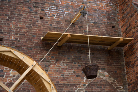 treadwheel crane, pulley and a hanging basket for heavy charge as demonstration of historical...