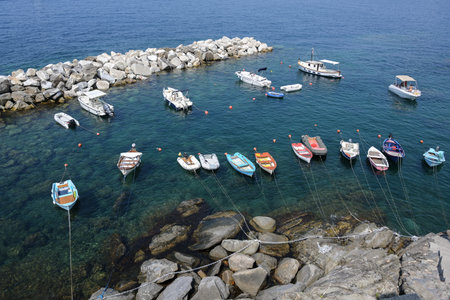 Leisure boats in a rocky natural harbor in the Mediterranean sea in italy, aerial view from above