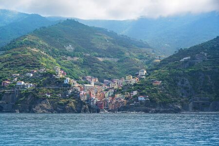 Riomaggiore on the Mediterranean Sea coast in the mountains, an ancient village with colorful houses from the cinque terre, famous tourism destination in Liguria, Italyの写真素材