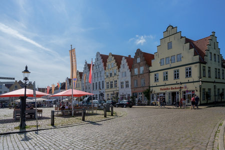 FRIEDRICHSTADT, GERMANY â AUGUST 23, 2019: houses  with stepped gables on the market square in Friedrichstadt, the beautiful town and travel destination in northern Germany founded by Dutch settlers, copy spaceのeditorial素材