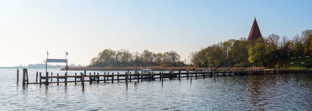 Long wooden jetty in the yacht port at the church in a bay on the island Poel near Wismar in the...