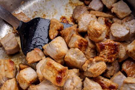 Searing pieces of pork meat are to get roasted aroma for a hearty stewの写真素材