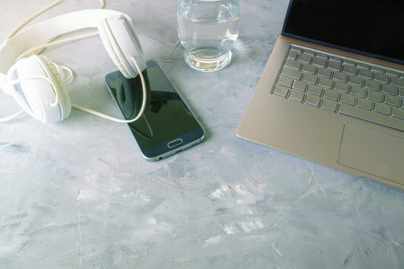 Laptop, headphones and smart phone