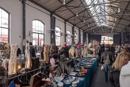 WISMAR, GERMANY, FEBRUARY 2, 2020: Indoor flea market with a lot of people and different used goods in a big hall at the city harbor of Wismar in Mecklenburg-Western Pomerania, selected focusのeditorial素材