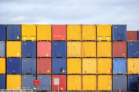Colorful freight containers stacked up on the quay for shipping in the cargo port of Luebeck