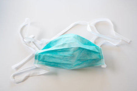 Face mask against droplet infection of contagious disease like coronavirus, light gray background,...