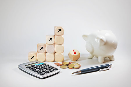 Financial concept profit and loss, rising and falling arrows on dices, piggy bank, calculator and some money on light greyの写真素材