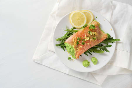 Organic onions freshly peeled in a bowl on a white painted table, healthy cooking at home during the coronavirus pandemic, copy space, high angle view from above, selected focusの写真素材