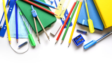 Stationery school supplies and among them a medical protection face mask, new normal concept against...