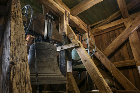 Gudow, Germany, November 13, 2020: Inside the old church tower from wooden construction with hanging bells and chiming drive mechanism in the St. Mary Church of the small village, Schleswig-Holstein, selected focus, narrow depth of fieldのeditorial素材