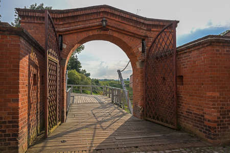 View to the draw bridge through the entrance gate of the historic brick fortress of Domitz on the river Elbe in northern Germany, copy space, selected focusの写真素材