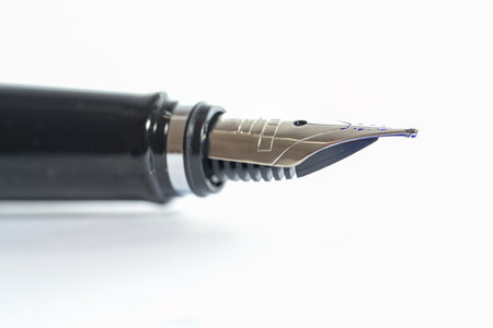 Detail of a classic fountain pen against a white background, copy space, selected focus and narrow depth of fieldの写真素材