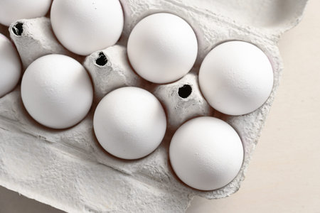 Part of a cardboard box with fresh white eggs, ingredients for cooking, baking, breakfast and...