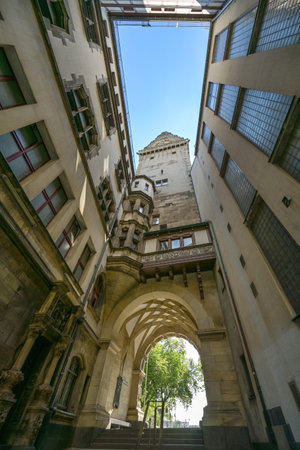 Inner courtyard of Duisburg town hall with tower and arch passage to the market place, view upwards to the blue sky, selected focusのeditorial素材