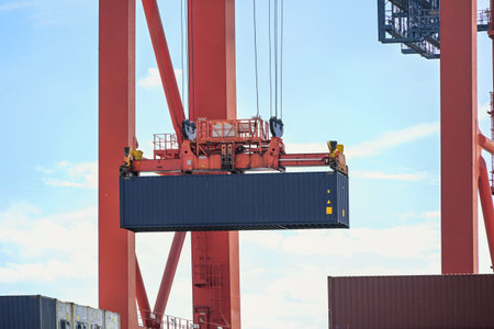 Terminal crane is moving a container in the industrial cargo for Hamburgt, concept for transport, shipping and logistics, coy space, selected focusの写真素材