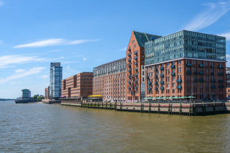 Hamburg, Germany, August 3, 2022: Modern buildings of red brick and glass from former warehouses on...