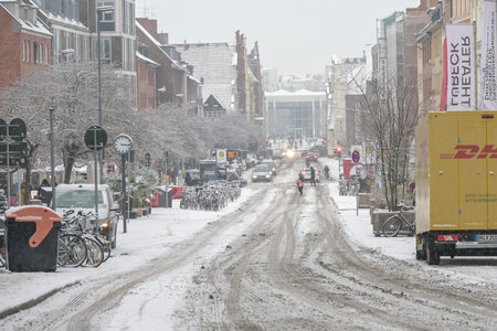 Lubeck, Germany, December 15, 2022: Snow and slush on a city street, dangerous weather for cars and pedestrians, winter traffic concept, copy space, selected focus, narrow depth of fieldのeditorial素材