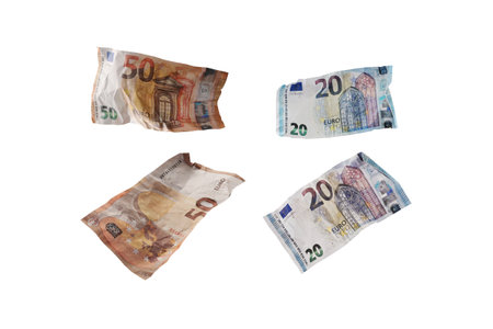 Used and crumpled fifty and twenty euro banknotes isolated on a white background, finance concept for money themes, business, investment or lottery, selected focusの写真素材