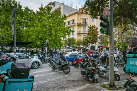 Thessaloniki, Greece, April 24, 2023: Traffic chaos with motorbikes and cars and difficult parking...