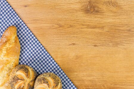 Fresh bread on wooden table background. Top view with space for your text.の写真素材