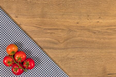 Italian food ingredients and checkered napkin on wooden table. Top view with space for your text.の写真素材