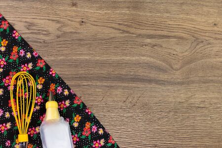 Baking tools. Pattern flower cloth napkin on empty wooden table. Top view with space for your text.の写真素材