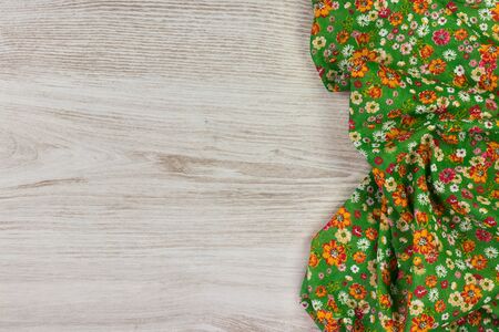 Floral pattern cloth napkin on empty wooden background. Top view with space for your text.の写真素材