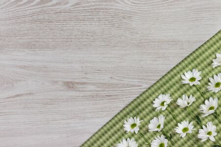 Fresh spring flowers and cloth napkin on white wooden plank. Flat lay, top view with space for your text.の写真素材