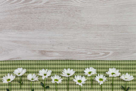 Fresh spring flowers and cloth napkin on white wooden plank. Flat lay, top view with space for your text.の写真素材