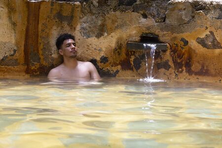 Hispanic Hispanic man in hot springs relaxing in Guatemalaの写真素材