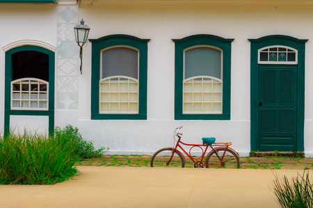 Bicycle parked in front of an old house in the historic city of Paraty, RJ, Brazil.の写真素材