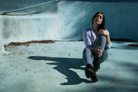 girl posing with jeans in a swimming poolの写真素材