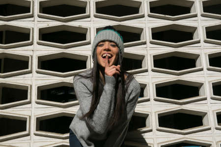 girl posing in winter style with a background patternの写真素材