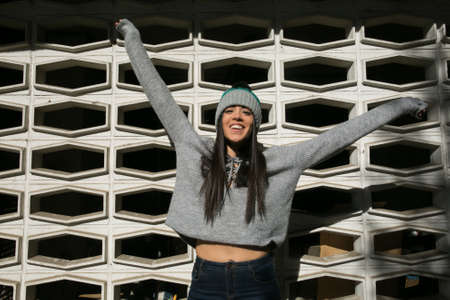 girl posing in winter style with a background patternの写真素材