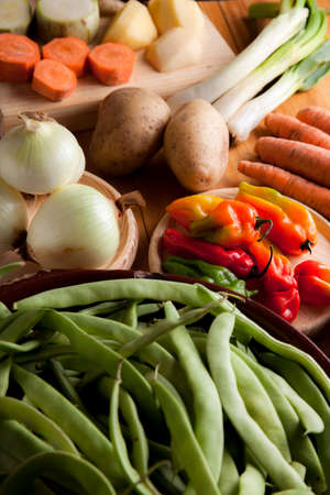 Prepare healthy vegetarian food ingredients, potatoes, carrots, onions, chili, beans, chives and zucchiniの写真素材