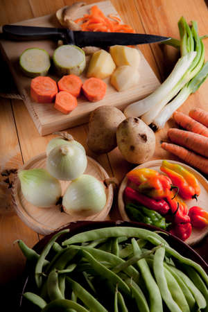 Prepare healthy vegetarian food ingredients, potatoes, carrots, onions, chili, beans, chives and zucchiniの写真素材