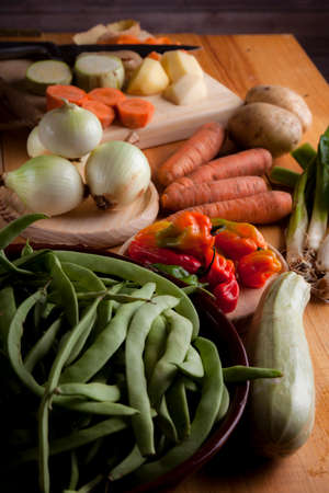 Prepare healthy vegetarian food ingredients, potatoes, carrots, onions, chili, beans, chives and zucchiniの写真素材