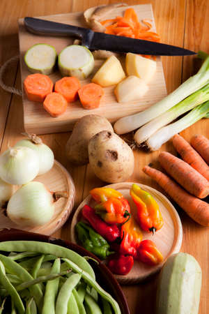 Prepare healthy vegetarian food ingredients, potatoes, carrots, onions, chili, beans, chives and zucchiniの写真素材