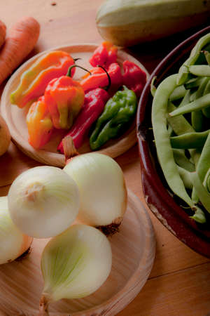 Prepare healthy vegetarian food ingredients, potatoes, carrots, onions, chili, beans, chives and zucchiniの写真素材