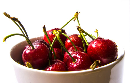 Fresh cherries isolated on white cupの写真素材