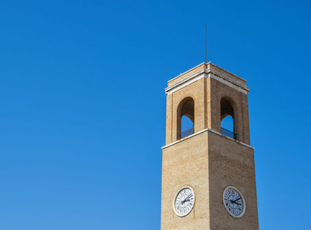 Belltower of church in Fano (Italy) over blue sky
