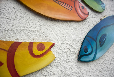 Decorative Wooden Fishes on rustic background. Sea concept.の写真素材