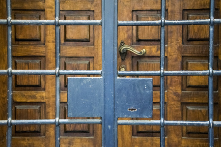 Wooden door with outer gate, Florence, Italy.の写真素材