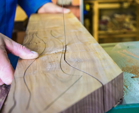 Carpenter workplace. Man using saw to cut wood.の写真素材