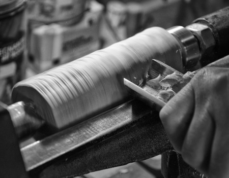 Worker turning wood on a lathe (black and white)の写真素材