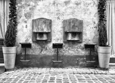 Vintage wooden stools outside Italian bars (black and white)の写真素材