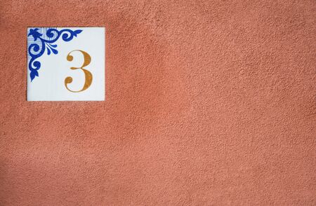 Traditional Italian home sign board painted on ceramic tile Placed on the wall. Number three (3)の写真素材