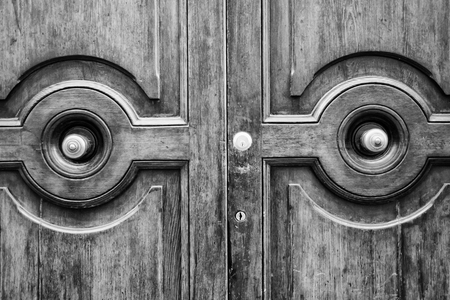 Details of an old wooden door in Florence, Tuscany, Italy (black and white).の写真素材